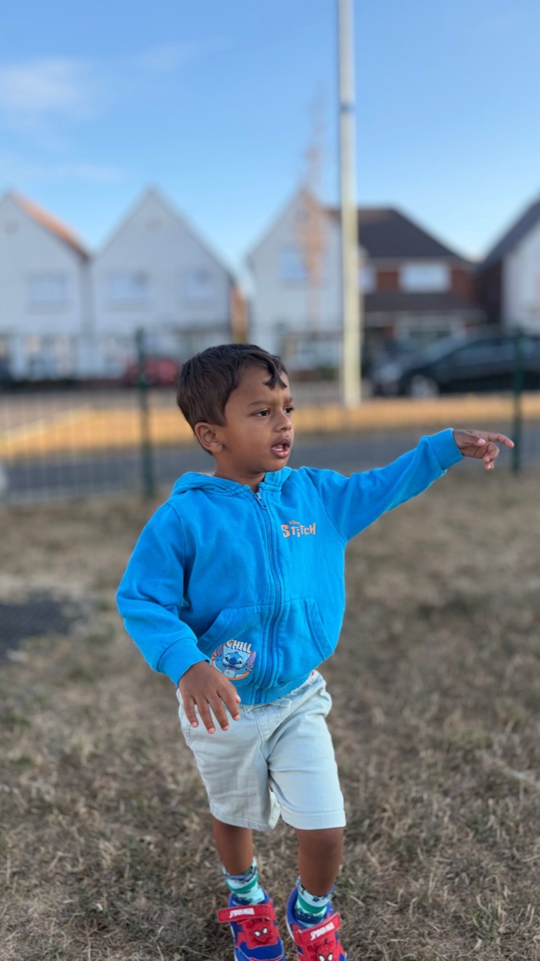Adrian in his blue hoodie, pointing